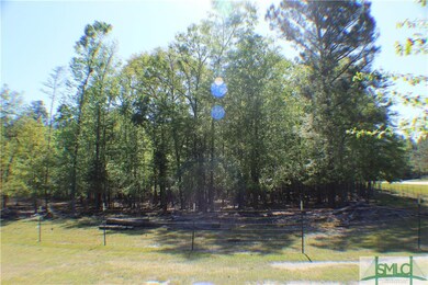 Fenced in wooded area is part of the acreage