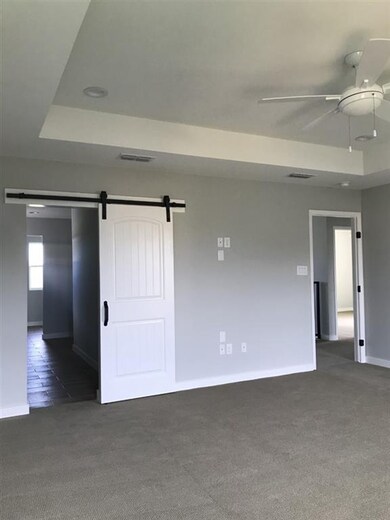 Spacious Master Bedroom with Barn Door Feature lea