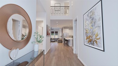 Hallway featuring light wood-type flooring, a hig