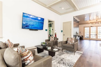 Living room featuring beam ceiling, hardwood / wood-style floors, wood ceiling, and french doors