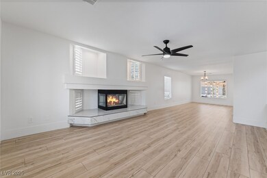 Unfurnished living room with a tile fireplace, lig