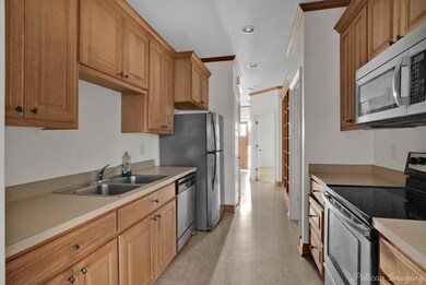 Kitchen with stainless steel appliances, sink, and