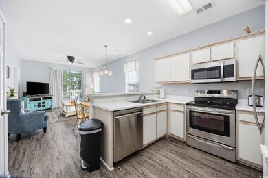 Kitchen with wood-type flooring, stainless steel a