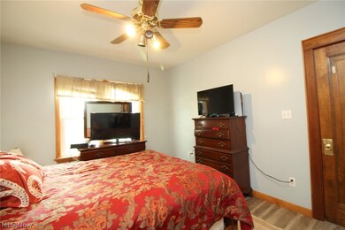 Bedroom with ceiling fan and light hardwood / wood-style flooring