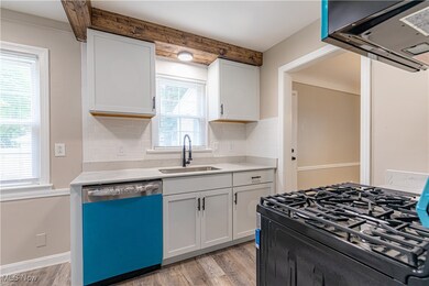 Kitchen featuring black range with gas cooktop, exhaust hood, dishwasher, light wood-style floors, and backsplash