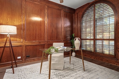 Office space with wooden walls and wood finished floors