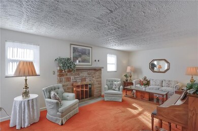 This sun filled space features a stone fireplace a