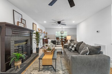 The dining room flows effortlessly into the living room, making it perfect for gatherings. There’s plenty of space for everyone to relax and enjoy.