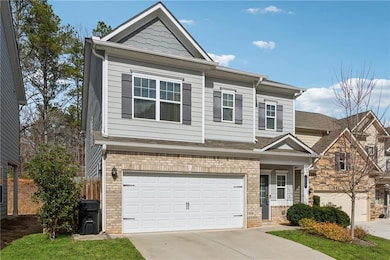 View of front of home featuring fence, concrete dr