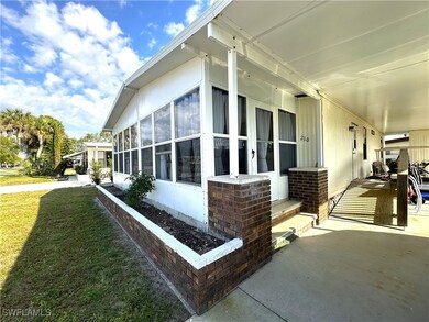 View of side of home featuring a yard and a sunroo