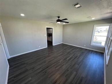 Spare room with visible vents, baseboards, a ceili