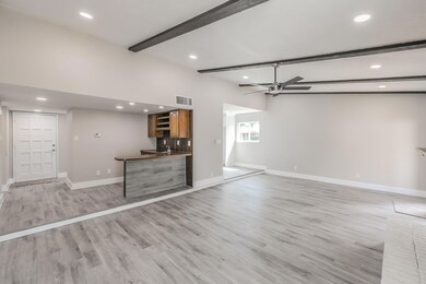 Unfurnished living room with beamed ceiling, ceili