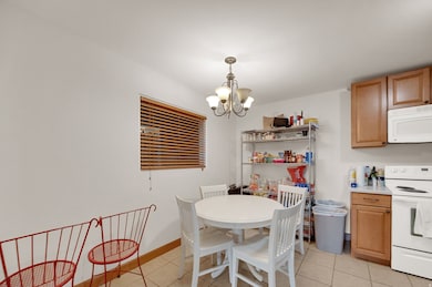 Dining room featuring light tile patterned floors and a chandelier