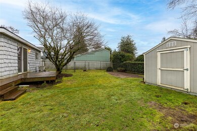 Back yard has large storage shed and dog run.
