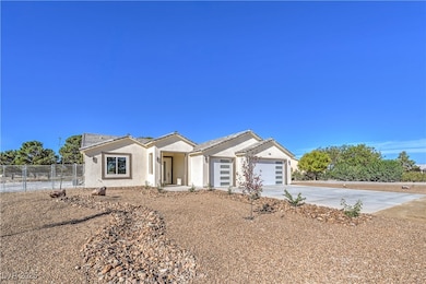 Single story home featuring driveway, stucco siding, and an attached garage