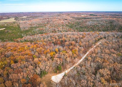 View of property location featuring a heavily wooded area