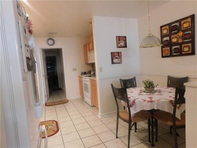 The kitchen features a nook for your table and cha