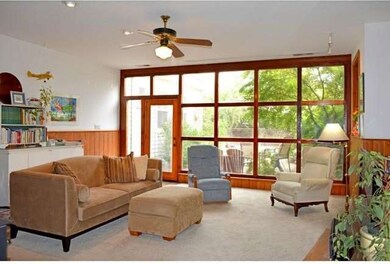 The wall of windows in the family room let it lots