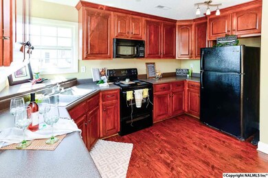 Generous counters and cabinets adorn this well planned kitchen.  Upgraded lighting and large windows make this area light and inviting. All appliances, including refrigerator, remain.