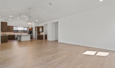 Open concept living spaces with vaulted ceiling