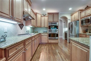 Your new Kitchen has maple cabinets with staggered heights, granite counters, tile backsplash, and stainless steel appliances, with a bar opening to the Great Room.   Enjoy the Thermador gas cooktop, and double ovens.