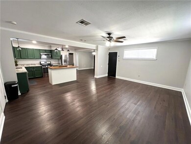 Spacious Den 19.5 x 15.7 Black door leads to drive