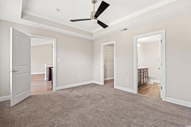 Unfurnished bedroom with ceiling fan, crown moldin