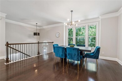 Dining space featuring a chandelier, hardwood / wood-style flooring, and ornamental molding