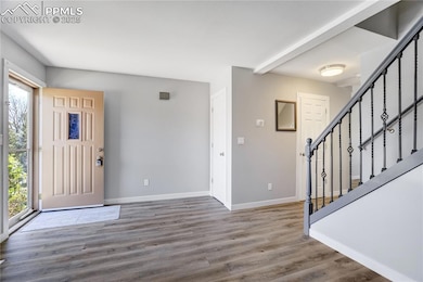 Foyer with plenty of natural light, baseboards, st