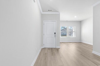 Interior space with crown molding and light wood-t