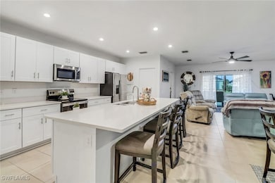 Kitchen featuring white cabinets, stainless steel