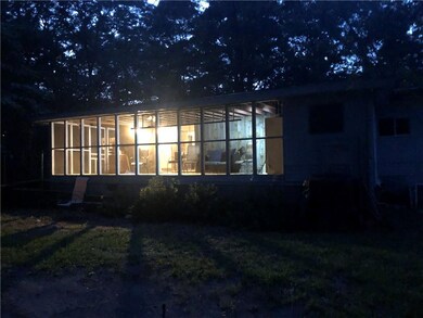Rear view of property with a sunroom