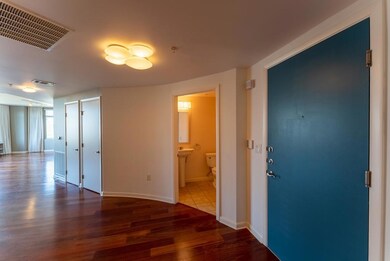 Corridor featuring dark wood-style floors and baseboards