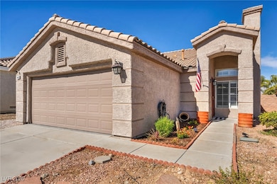 View of front of property with a garage, driveway,