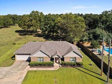 View of front of property with a fenced in pool, a