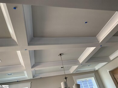 Dining room offers coffered ceiling with cove crow