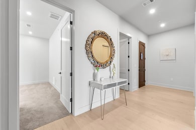 Corridor with recessed lighting, visible vents, a