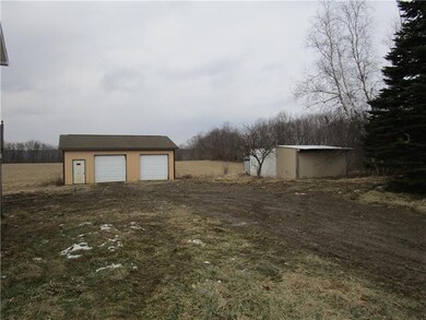 oversized garage and wood shanty