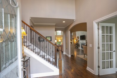 Enter the home through the decorative glass front door into a spacious 2-story foyer.  You will immediately feel the open flow this house offers.  The rich hardwood floors start here and spread through the entire first floor.