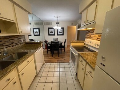 Kitchen opens into a dining area with laminate-woo