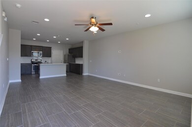 Unfurnished living room featuring a ceiling fan, 