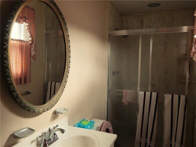 BATHROOM WITH SHOWER AND SHOWER DOORS.