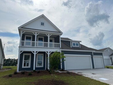 View of front of home with a balcony, a garage, an