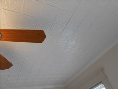 Please notice the original tin ceiling in the both
