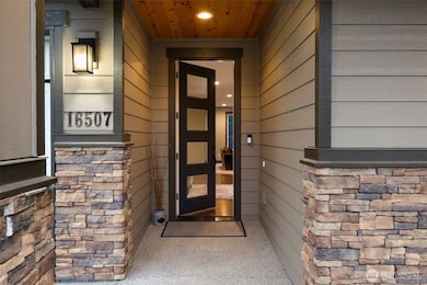 The grand covered front entry has a cedar ceiling to welcome your guests.