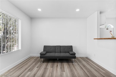 Living area featuring baseboards, and recessed lighting