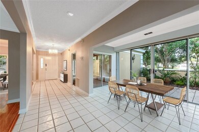 Virtually staged. FOYER at entry and SUNROOM.