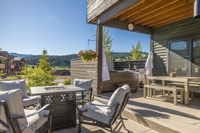Patio with fire pit table and hot tub