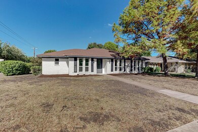 Ranch-style home featuring a front lawn