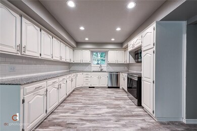 Large open kitchen with all new appliances and tons of storage, including a pantry.
